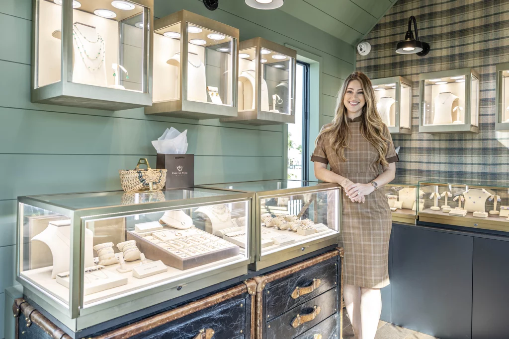 Photo of young woman, Karina Brez, standing inside a jewelry store housed in a upscale mobile space,